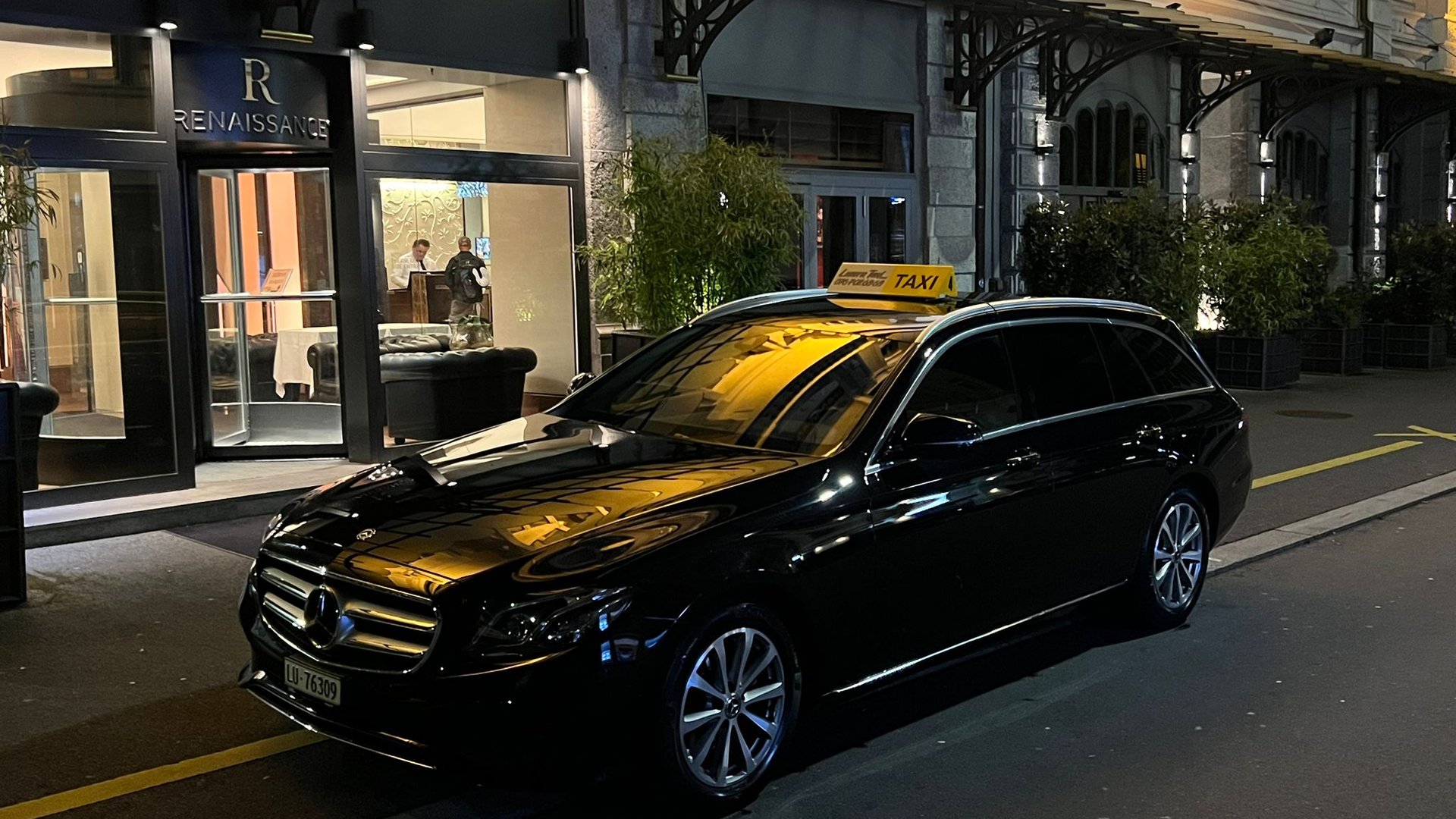 Luzerner Taxi Mercedes E-Class outside the entrance of the Renaissance Lucerne Hotel